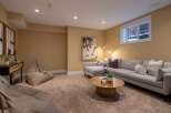 This inviting living space features a modern sectional sofa, perfect for relaxing and entertaining.
