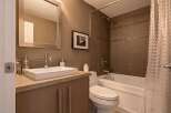 Step into this modern bathroom, featuring a sleek vanity with a rectangular sink and ample storage.