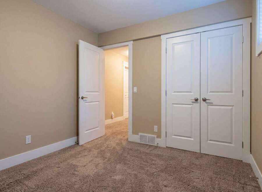 Step into this inviting space, featuring a neutral color palette and plush carpeting.