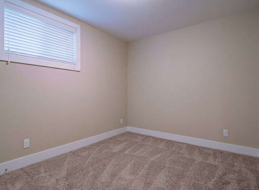Step into this inviting room, featuring neutral walls and a cozy carpet, perfect for creating a warm and welcoming atmosphere.