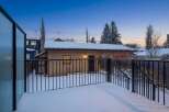 Enjoy the serene beauty of this property, featuring a snow-covered deck and a charming exterior.