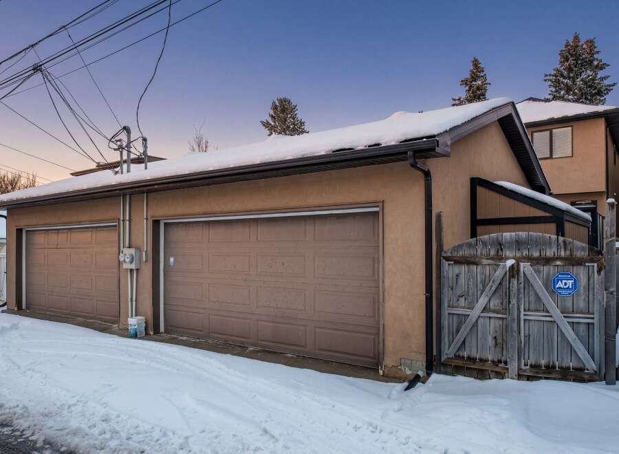 This charming property features a detached garage with two bays, perfect for parking and storage.