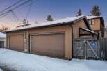 This charming property features a detached garage with two bays, perfect for parking and storage.