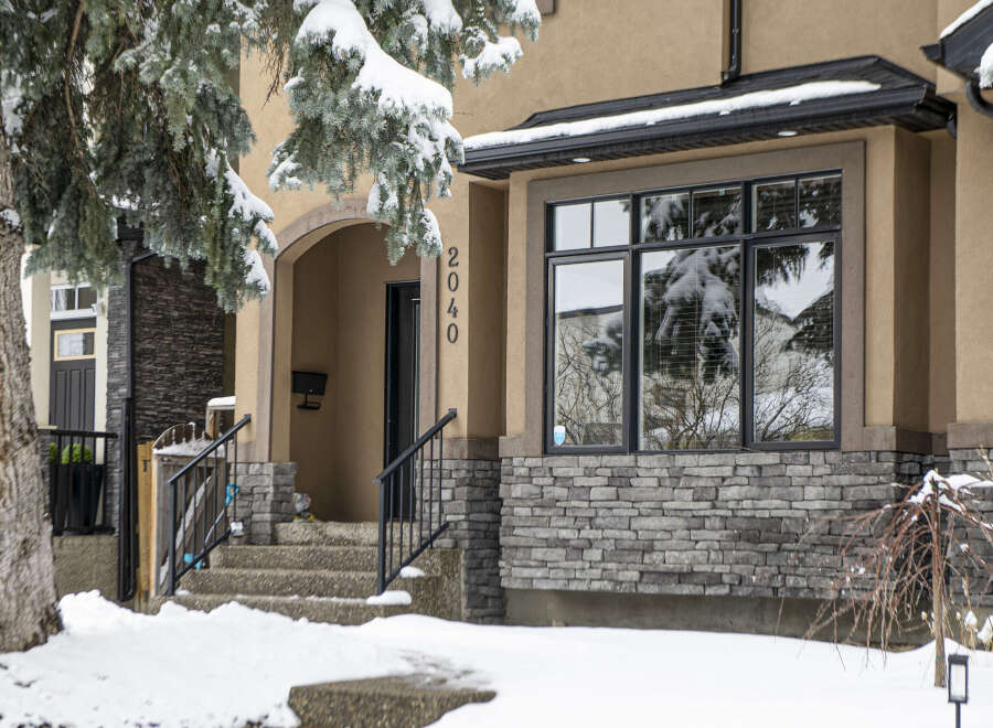 This stunning property boasts a beautiful facade with a combination of stone and stucco, creating an inviting curb appeal.