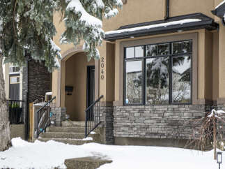 This stunning property boasts a beautiful facade with a combination of stone and stucco, creating an inviting curb appeal.