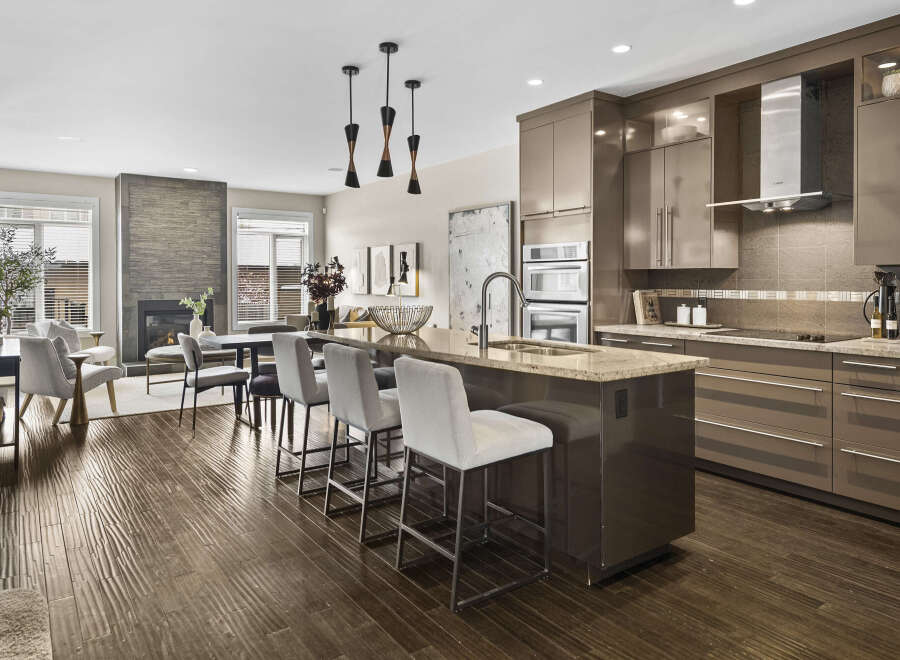 Step into luxury with this stunning kitchen! Featuring a spacious island with seating, modern appliances, and sleek cabinetry, this kitchen is perfect for both everyday living and entertaining.