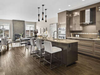 Step into luxury with this stunning kitchen! Featuring a spacious island with seating, modern appliances, and sleek cabinetry, this kitchen is perfect for both everyday living and entertaining.