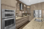 This modern kitchen boasts sleek, high-gloss cabinetry and stainless steel appliances, creating a sophisticated and functional space.