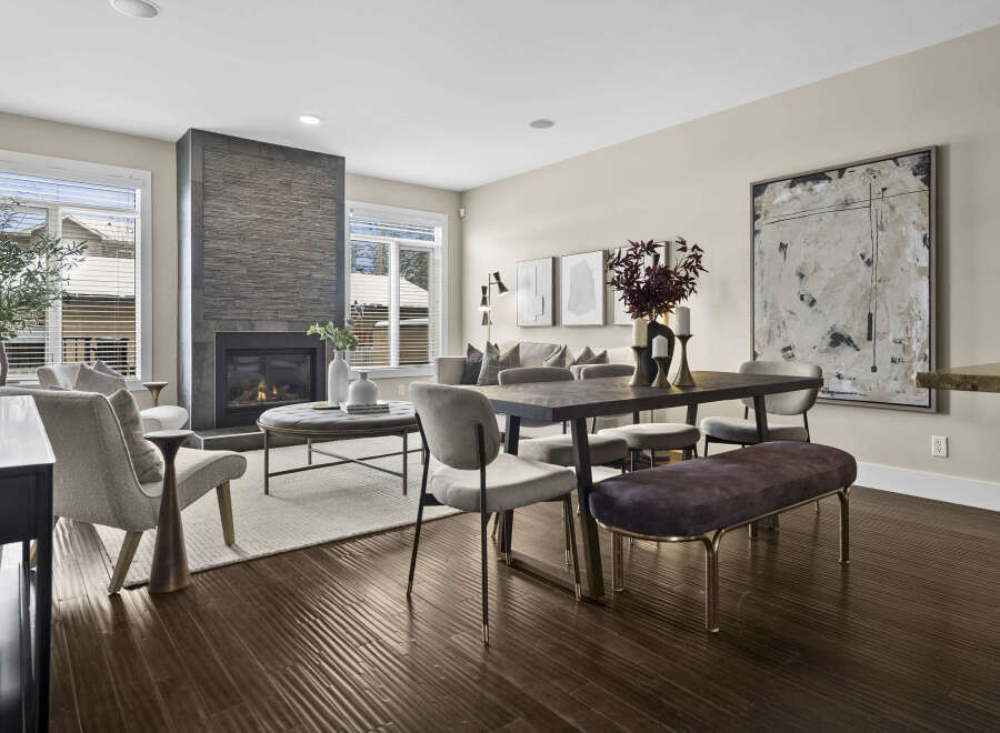 Step into luxury with this stunning living space, featuring a modern fireplace and elegant dining area.