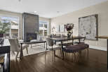 Step into luxury with this stunning living space, featuring a modern fireplace and elegant dining area.