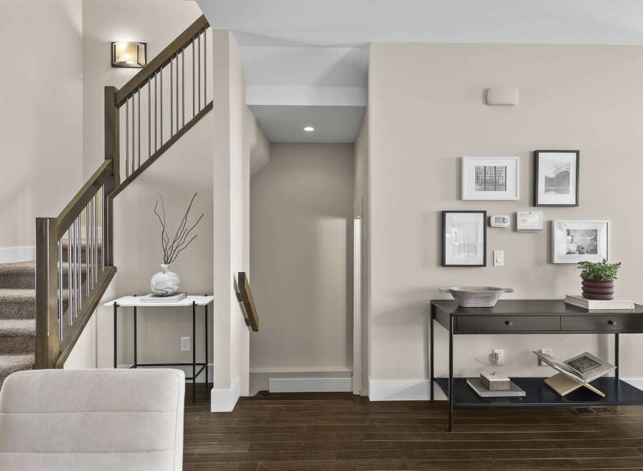 Step into this inviting home featuring a stunning staircase with elegant wooden accents and a modern railing design.