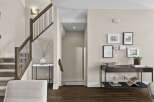Step into this inviting home featuring a stunning staircase with elegant wooden accents and a modern railing design.