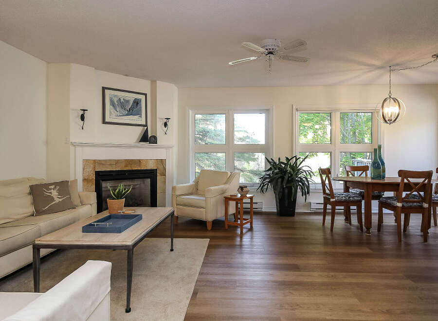 Step into this inviting living space, featuring a cozy fireplace and a comfortable seating area, perfect for relaxation.