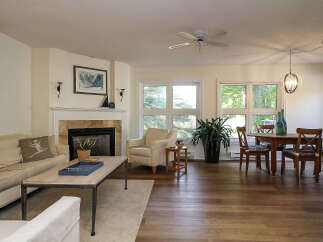 Step into this inviting living space, featuring a cozy fireplace and a comfortable seating area, perfect for relaxation.