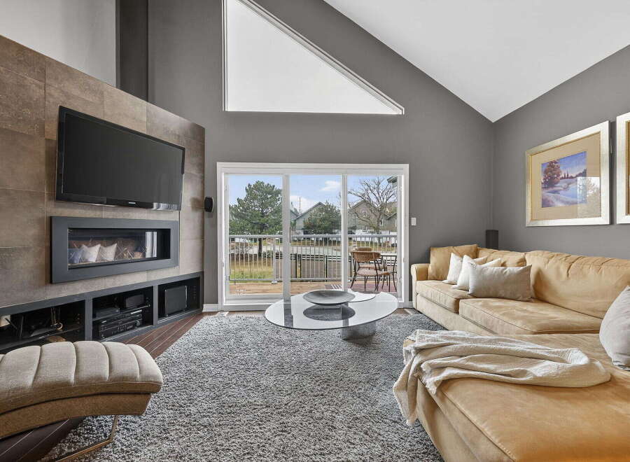 Step into luxury with this stunning living room, featuring a modern fireplace and a sleek entertainment center.