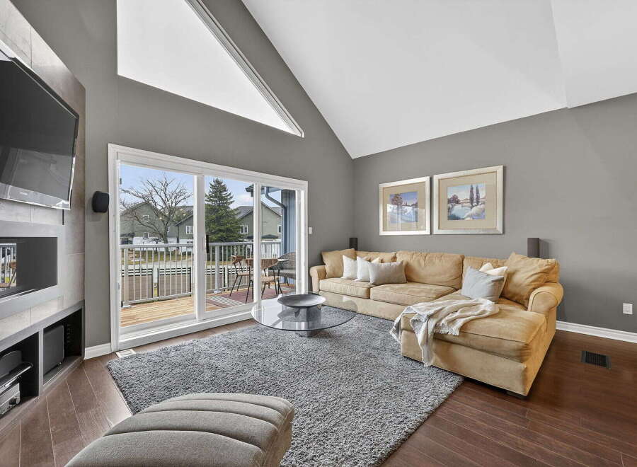 Step into luxury with this stunning living room, featuring a cozy sectional sofa and a plush area rug.
