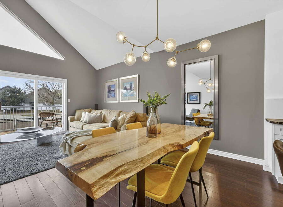 Step into luxury with this stunning property, featuring a spacious living area and a modern dining space.