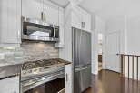 This stunning kitchen boasts modern appliances and elegant design.