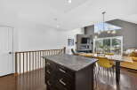 This stunning property boasts a modern kitchen with a sleek island and dark cabinetry, perfect for culinary enthusiasts.