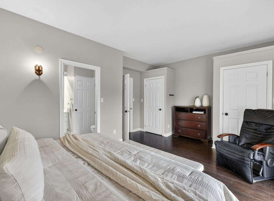 Step into this inviting bedroom, featuring a comfortable bed and ample space.