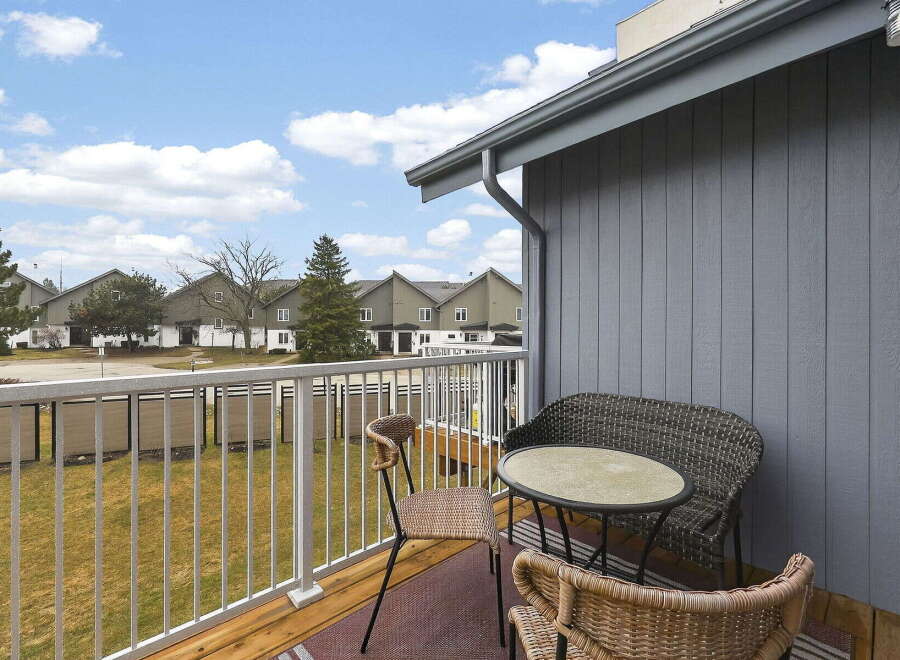 Enjoy serene outdoor living on this charming balcony, perfect for morning coffee or evening relaxation.