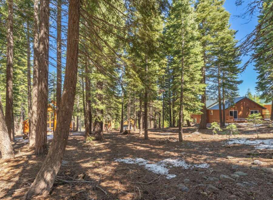 Nestled in a serene forest setting, this property offers a tranquil escape.