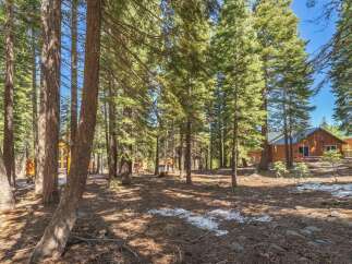 Nestled in a serene forest setting, this property offers a tranquil escape.