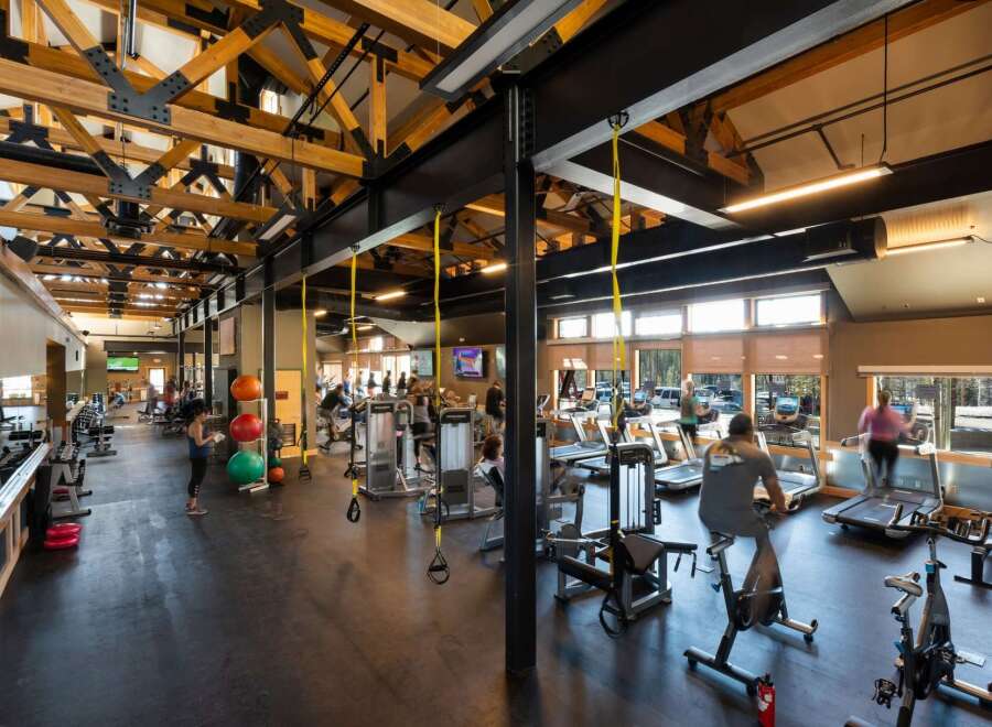 This stunning fitness center boasts a spacious layout with high ceilings and ample natural light, creating an inviting atmosphere for workouts.