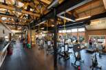 This stunning fitness center boasts a spacious layout with high ceilings and ample natural light, creating an inviting atmosphere for workouts.