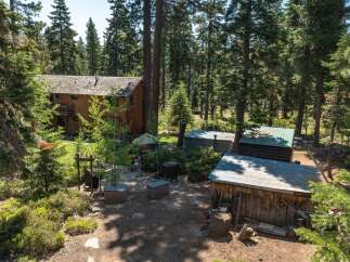 Nestled in a serene forest setting, this property offers a unique blend of rustic charm and natural beauty.