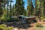Nestled in a serene forest setting, this property offers a unique retreat.