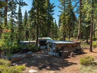 Nestled in a serene forest setting, this property offers a unique retreat.