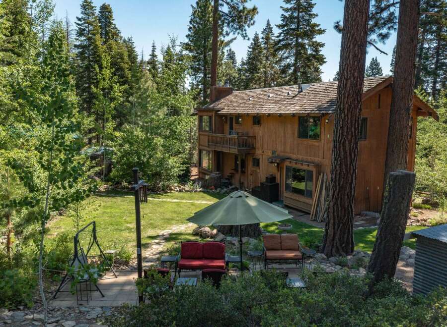 Nestled in a serene, wooded setting, this stunning property offers a perfect blend of nature and comfort.