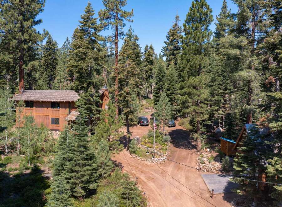 Nestled amidst towering trees, this stunning property offers a serene escape.