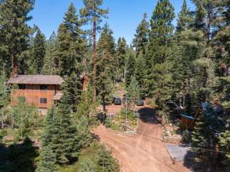 Nestled amidst towering trees, this stunning property offers a serene escape.
