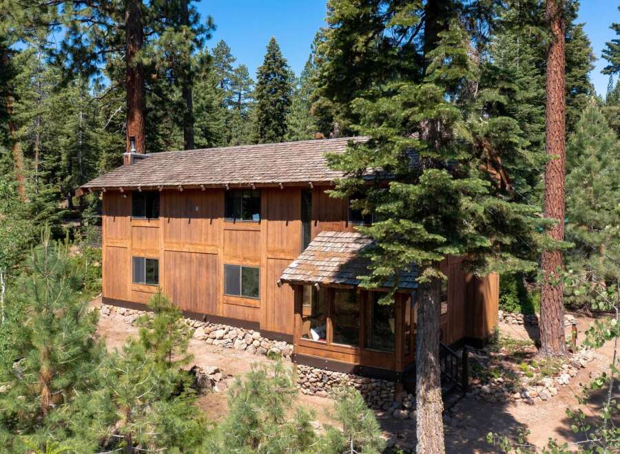 Nestled amidst a lush forest, this stunning wooden home offers a serene retreat.
