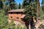 Nestled amidst a lush forest, this stunning wooden home offers a serene retreat.