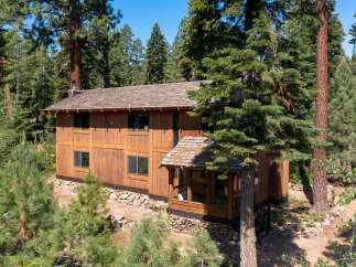 Nestled amidst a lush forest, this stunning wooden home offers a serene retreat.