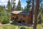 Nestled amidst towering trees, this stunning wooden cabin offers a serene escape.