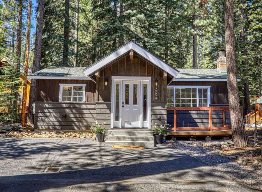 Nestled amidst towering trees, this charming cabin offers a serene escape.