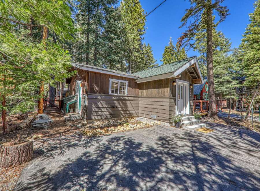 Nestled amidst towering trees, this charming cabin offers a serene escape.