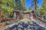Nestled amidst towering trees, this charming cabin offers a serene escape.