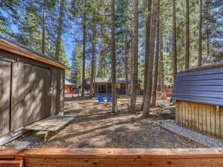 Nestled amongst towering trees, this charming property offers a serene escape.