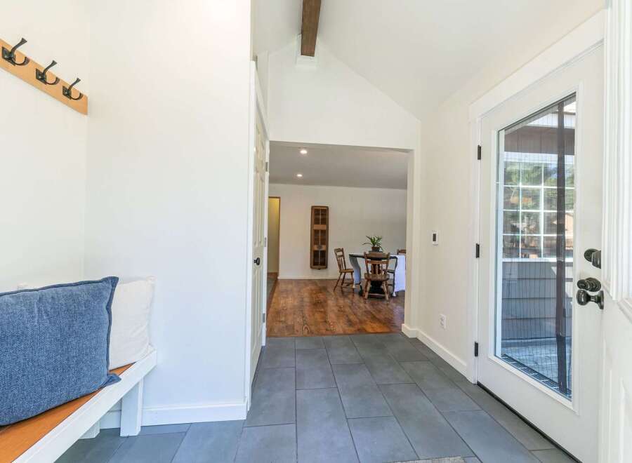 Step into this inviting entryway, showcasing a blend of modern and rustic design.