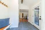 Step into this inviting entryway, showcasing a blend of modern and rustic design.