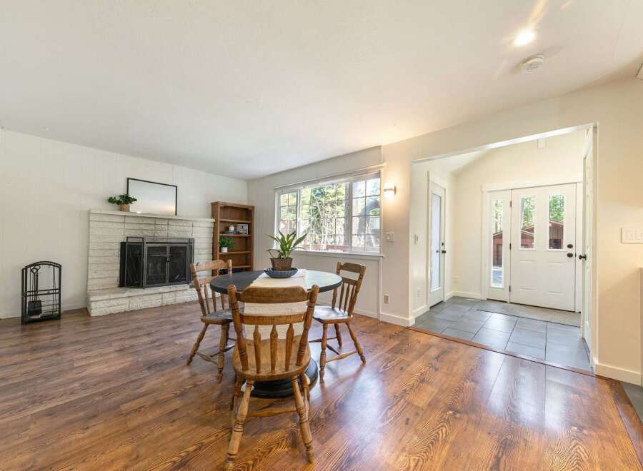 This charming home features a cozy living space with a fireplace, perfect for relaxing evenings.