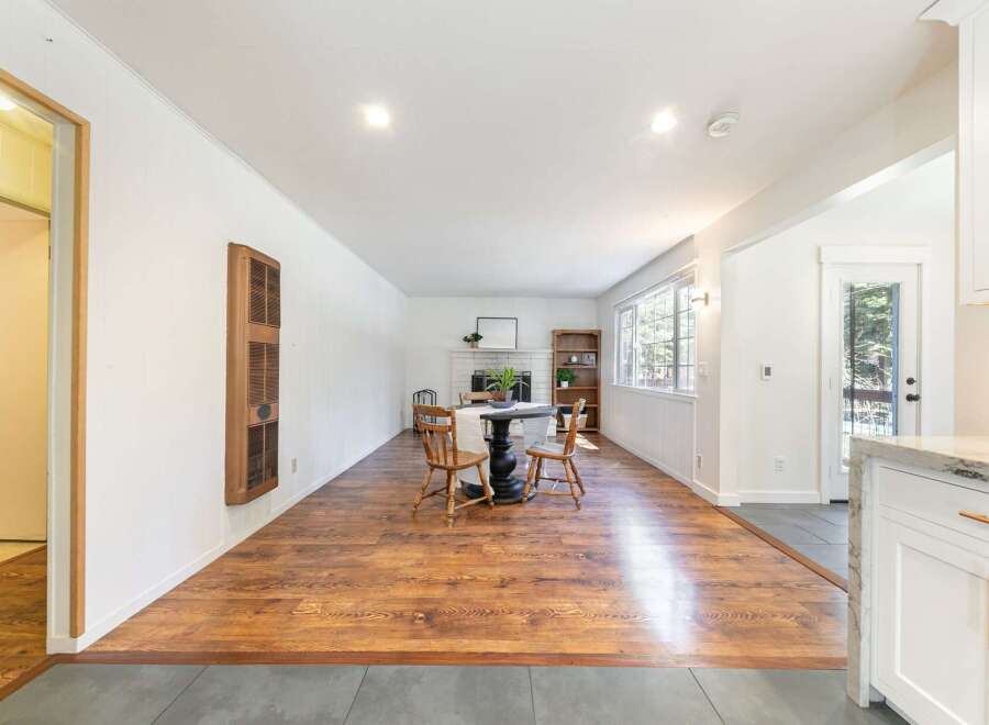 Step into this inviting living space, featuring a cozy dining area with a charming table and chairs.