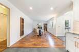 Step into this inviting living space, featuring a cozy dining area with a charming table and chairs.