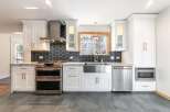This stunning kitchen boasts modern design with high-end appliances and finishes.