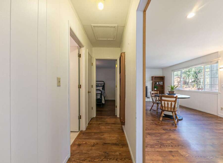 Step into this inviting home and discover a hallway leading to a bright living space.